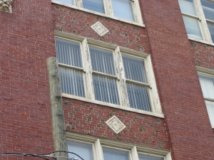 Example of paint deterioration on historic wood windows, though wood remains in sound condition for the time being.